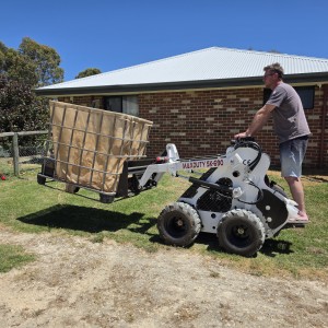 Mini skid steer with pallet forks
